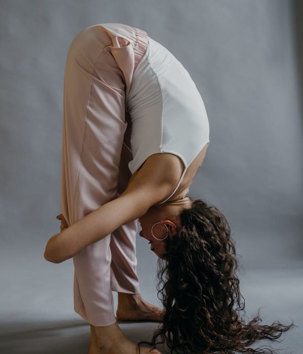 A person in a fluid yoga pose, suggesting continuous movement and flow.