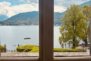 A window with a view of green trees, symbolizing fresh air and breathing.
